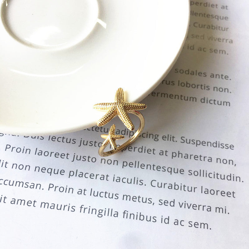 Eleganter verstellbarer Ring im Seestern-Design aus edlem Silber und Gold