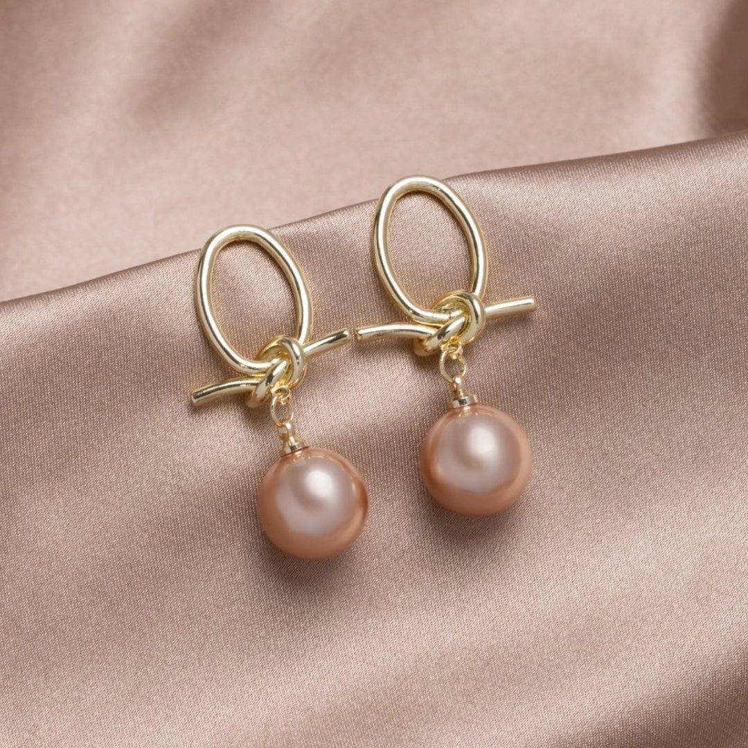Elegante Goldohrringe mit Perlenschleifen