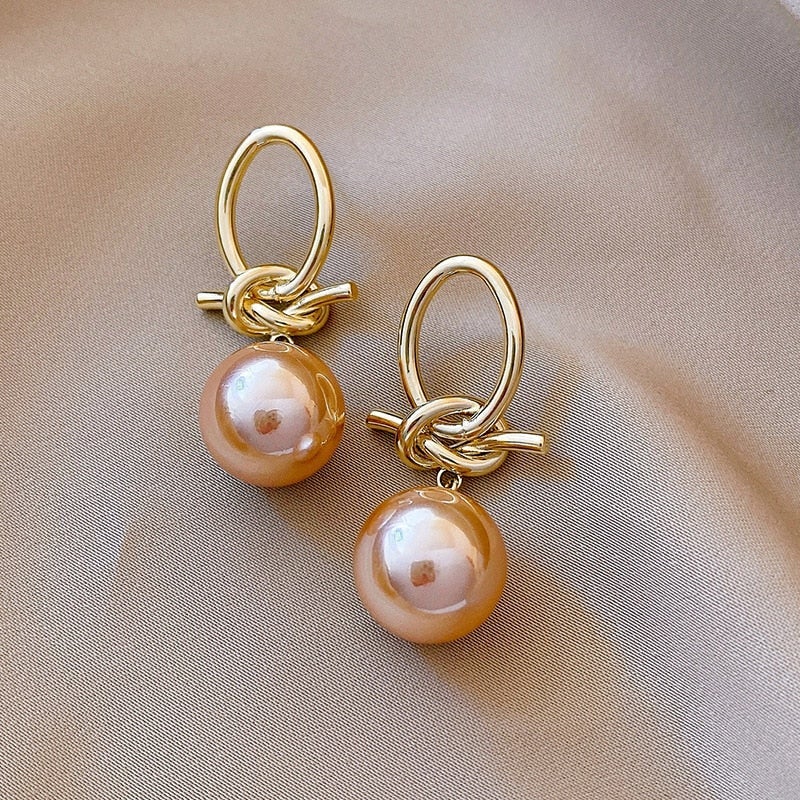 Elegante Goldohrringe mit Perlenschleifen
