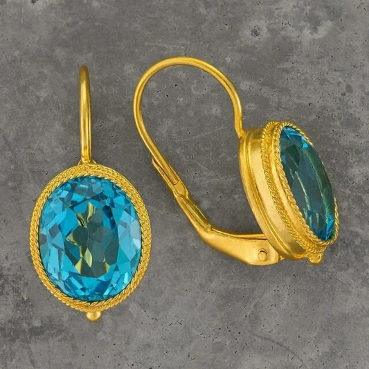 Elegante Vintage-Ohringe mit funkelndem blauen Kristall in edlem Gold